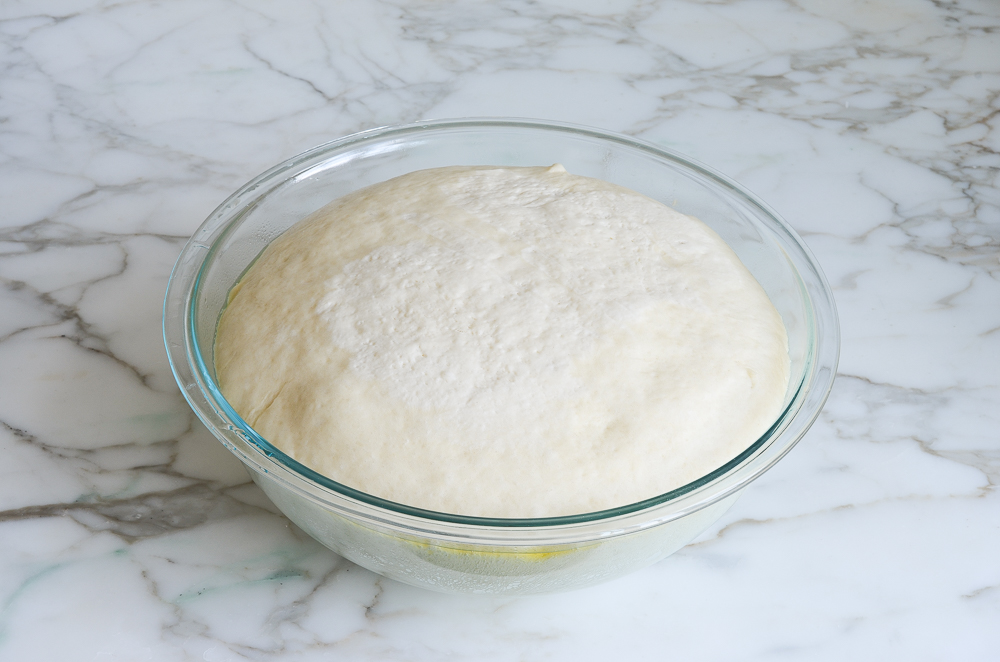 placing dough on oiled baking sheet