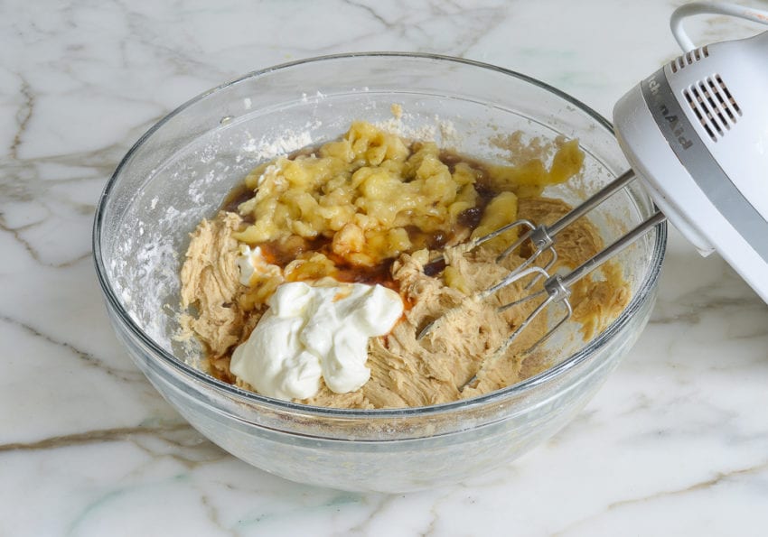 Bananas, sour cream, and vanilla in a bowl with dough.