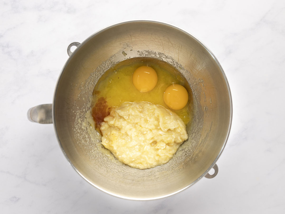melted butter, sugar, eggs, bananas, and vanilla combined in metal mixing bowl