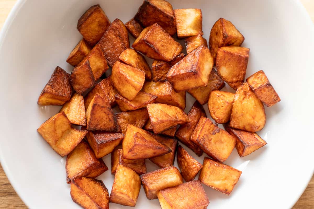fried cubed potatoes on a plate