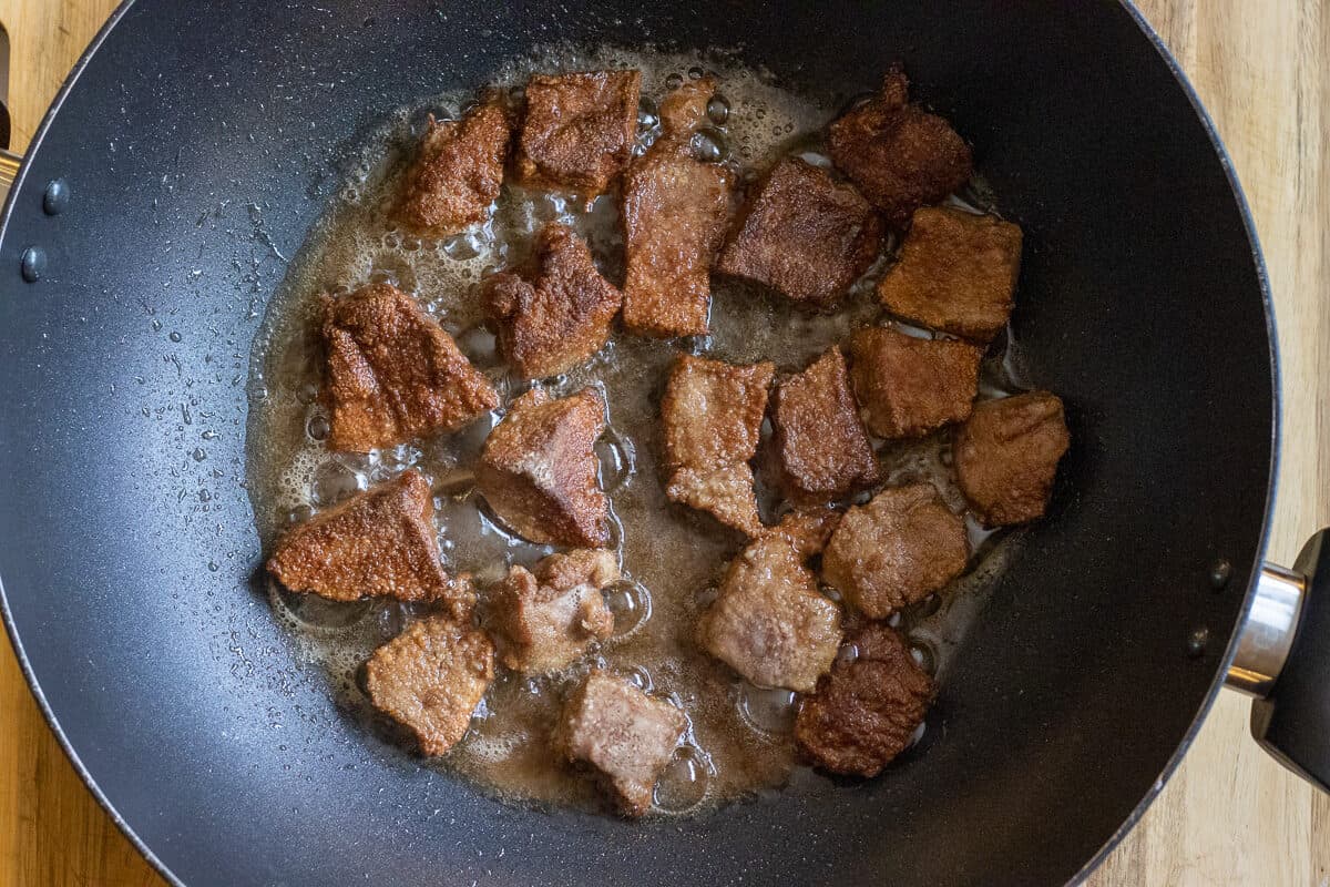 frying the liver pieces in a wok with oil
