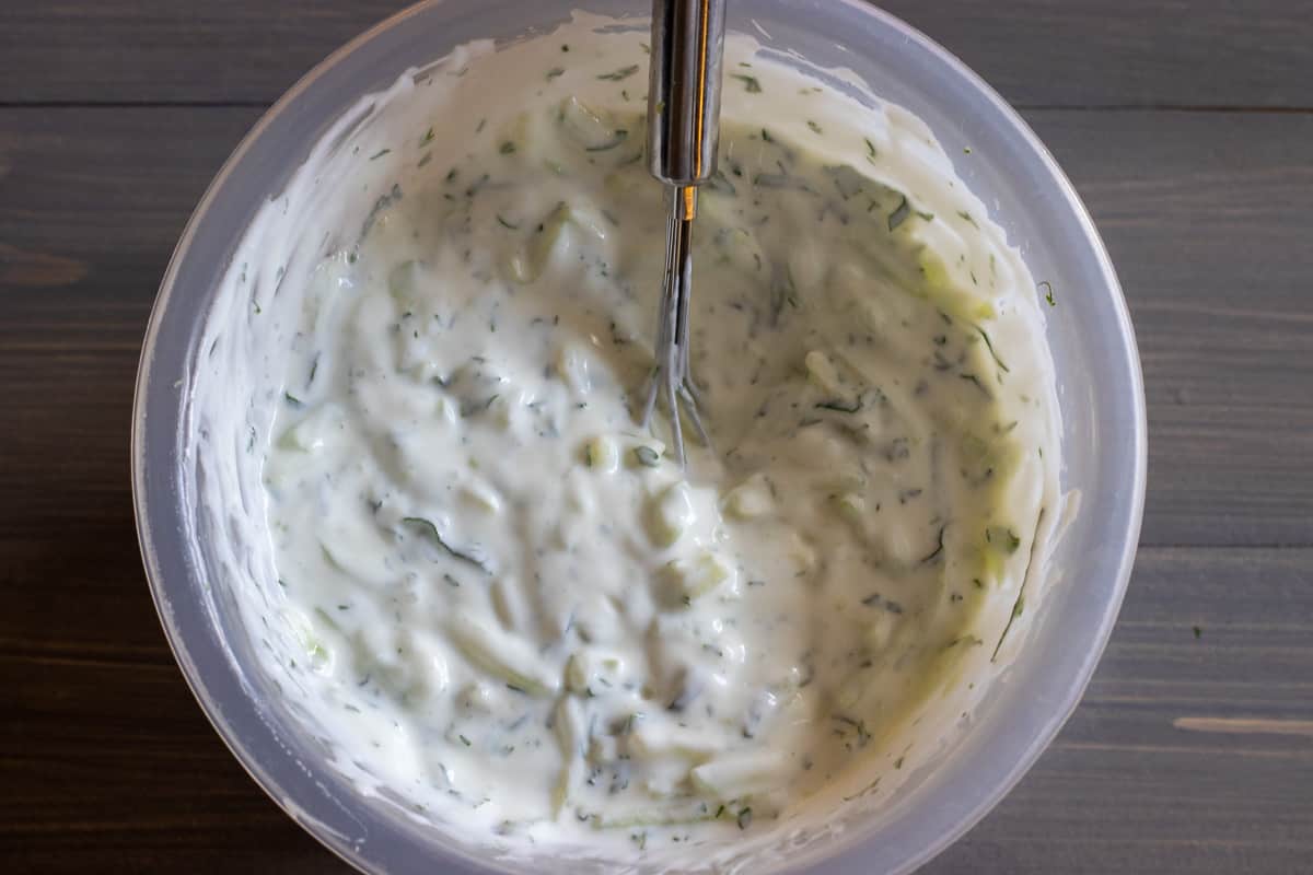 cucumbers and herbs are mixed with yoghurt