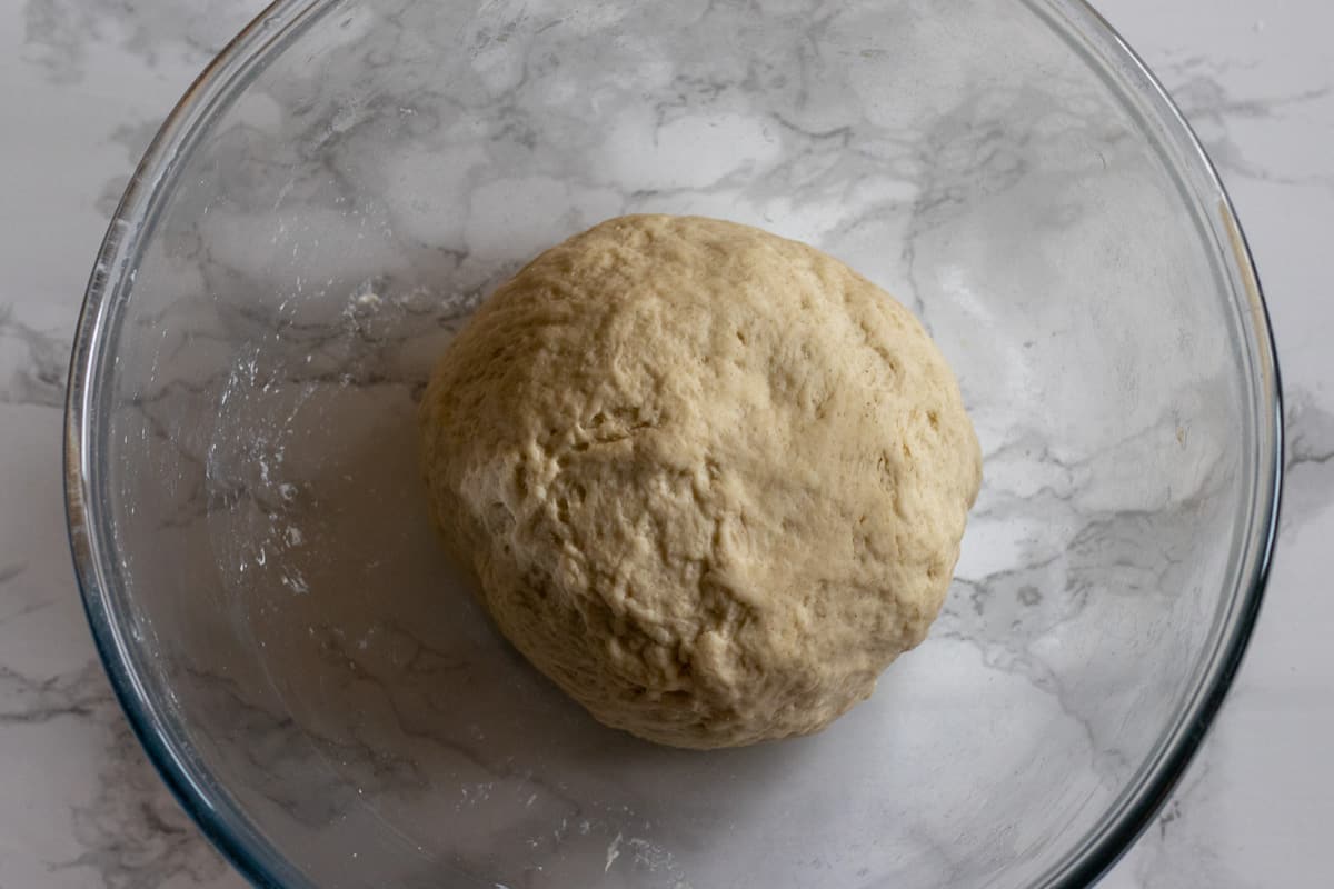 A soft dough with water, salt and flour is made for Chebureki 