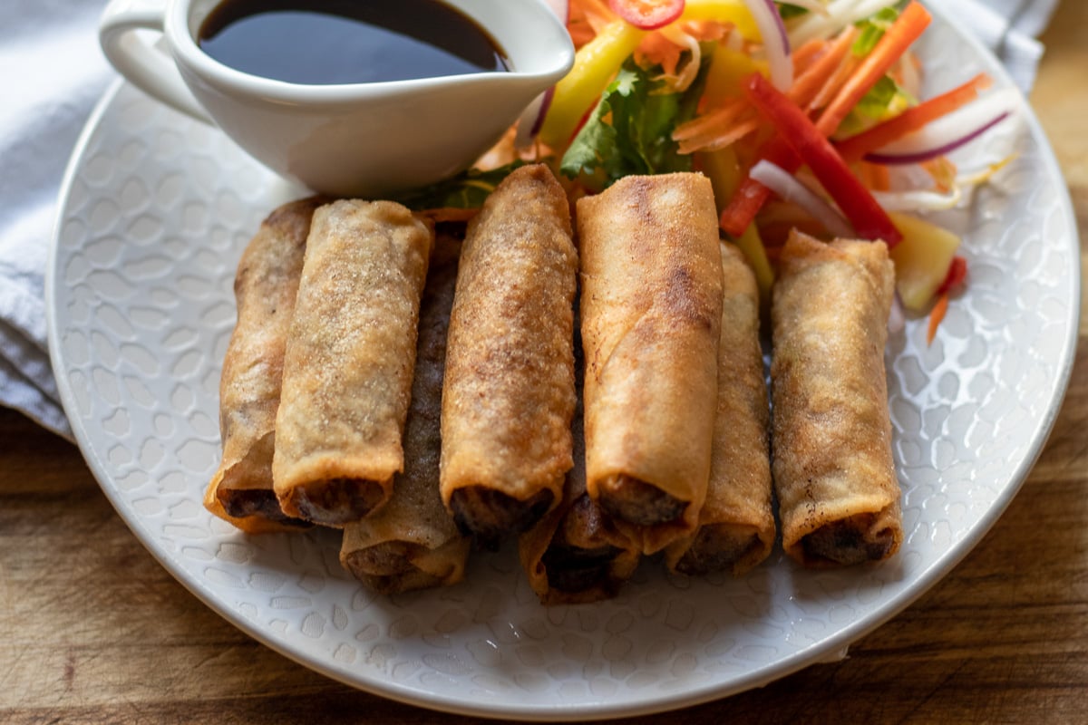 duck rolls served with salad and hoisin sauce