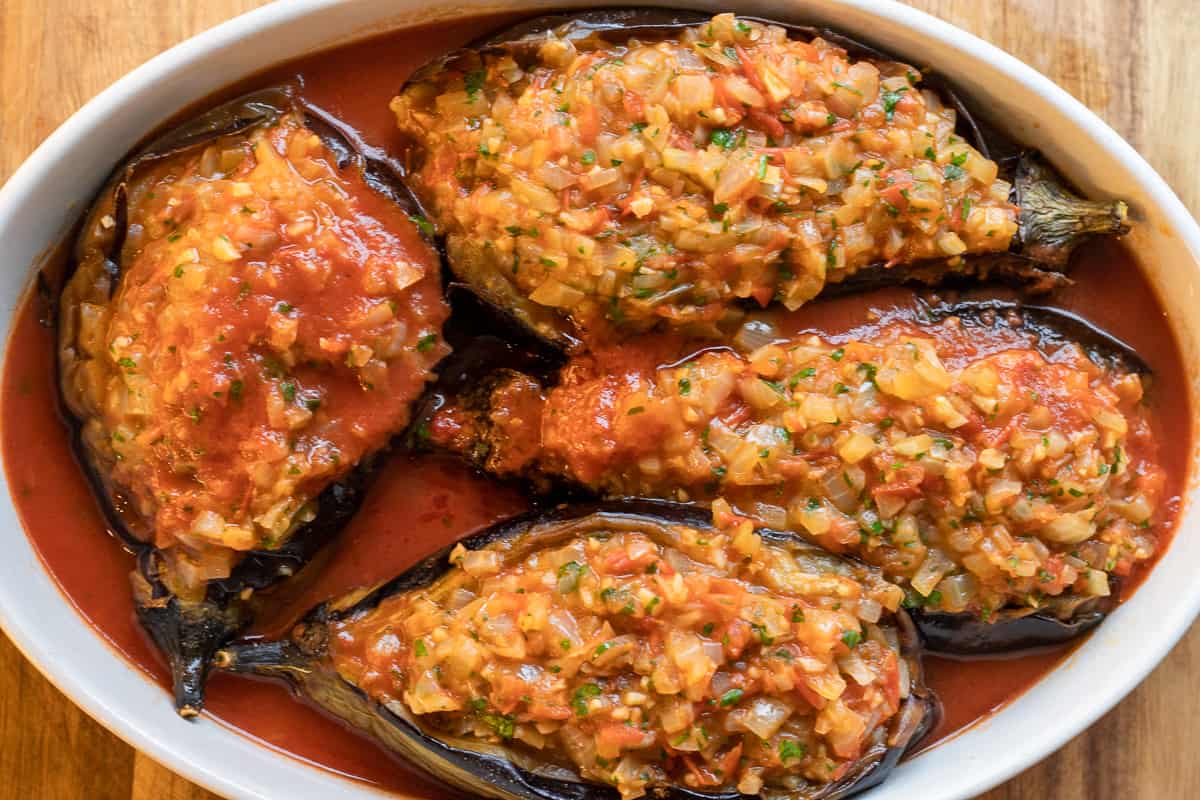 Eggplants are filled and drizzled on with tomato sauce