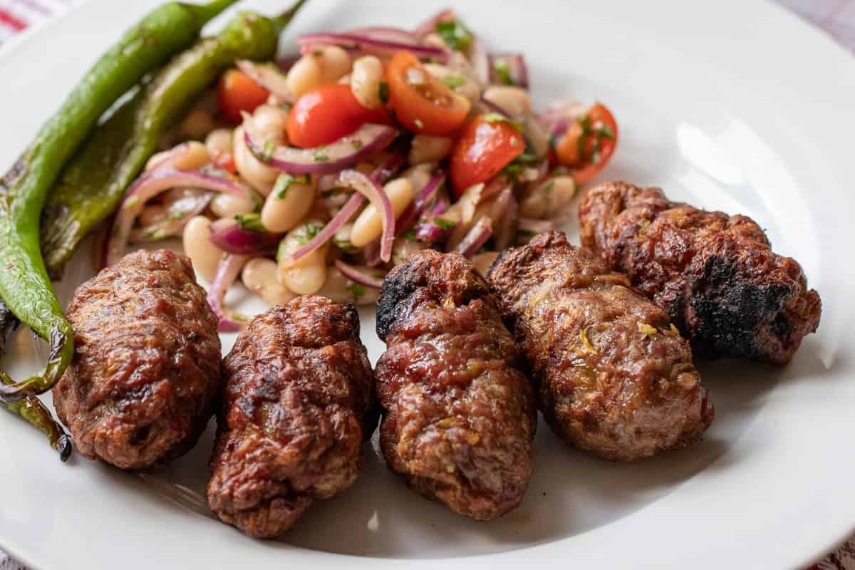 5 pieces of inegol kofte is served with Piyaz and grilled chillies