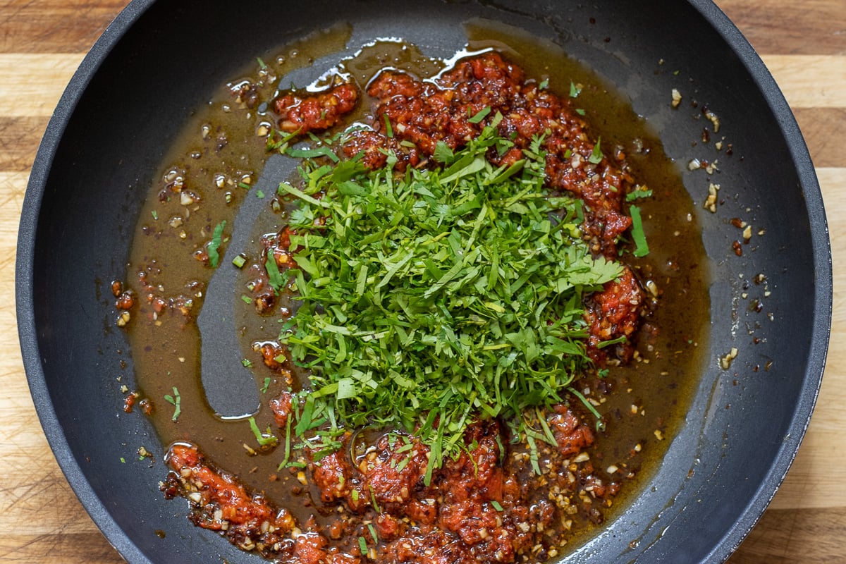 chopped cilantro is added to the sauce