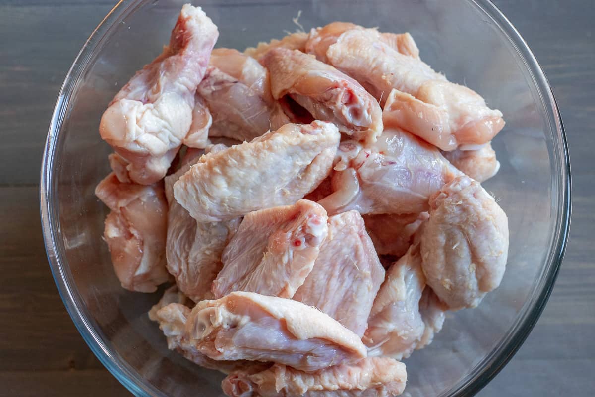 chicken wings are prepared and placed in a bowl.