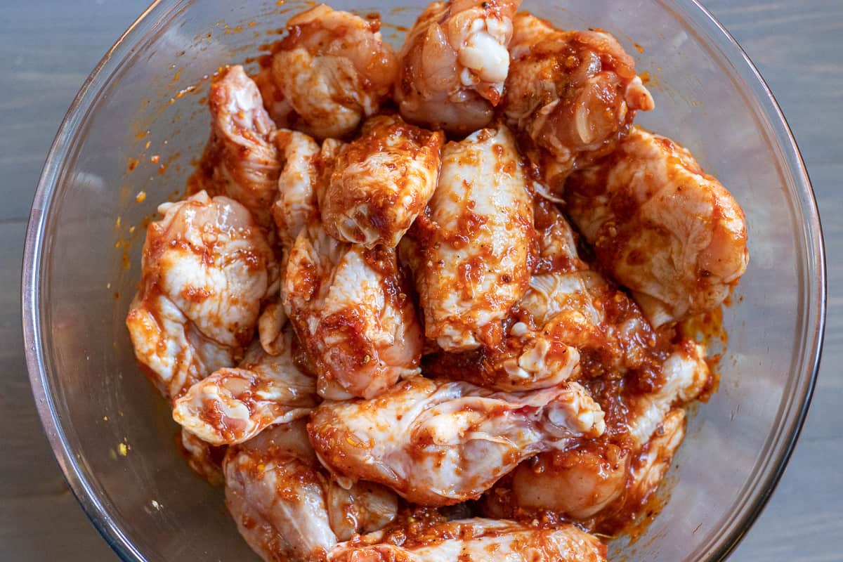 chicken wings are covered with spicy and sticky marinade