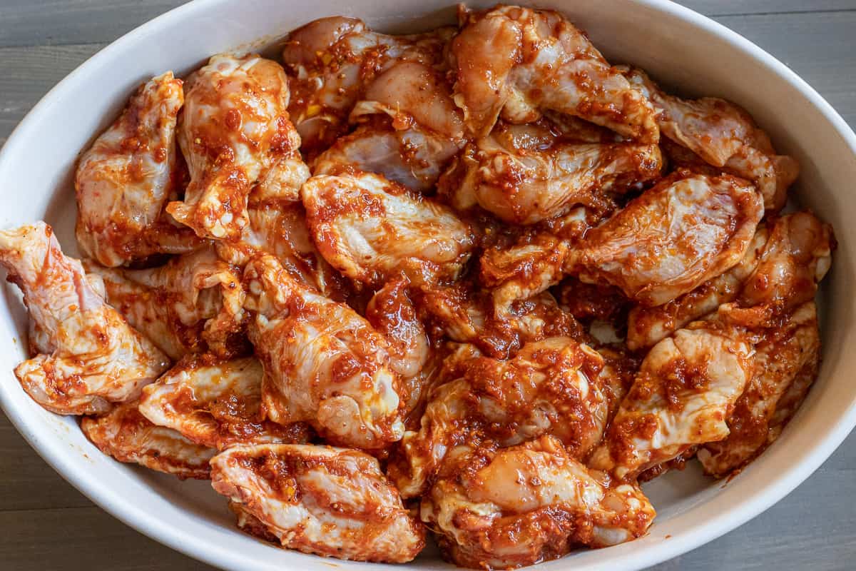 chicken wings are placed in an oven dish 