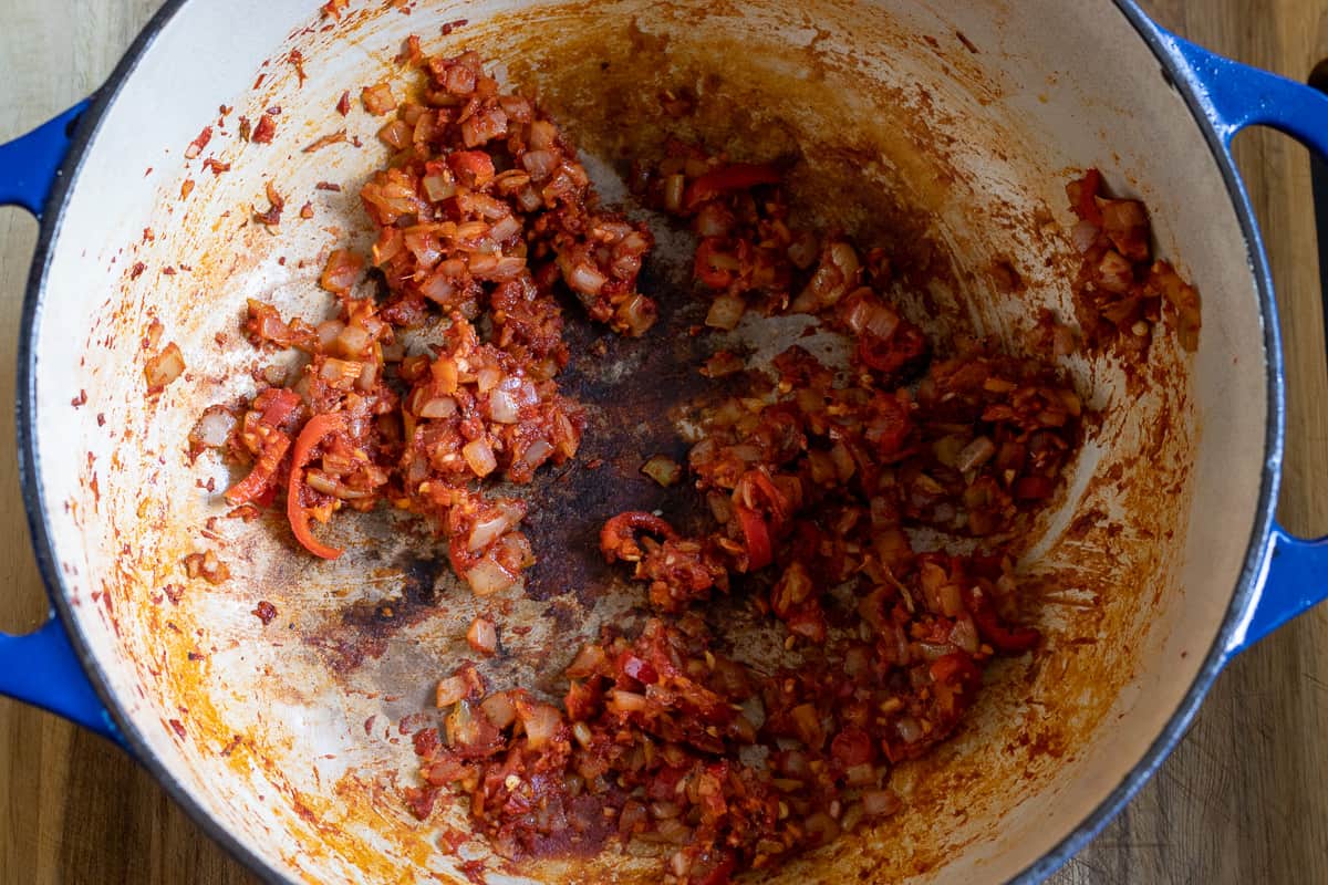 garlic and tomato paste are added to the onions