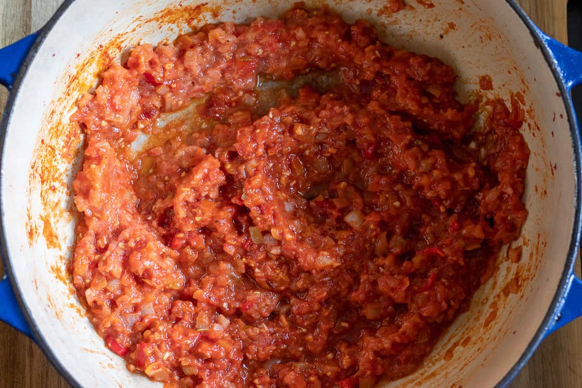 the grated tomatoes are added to the onions