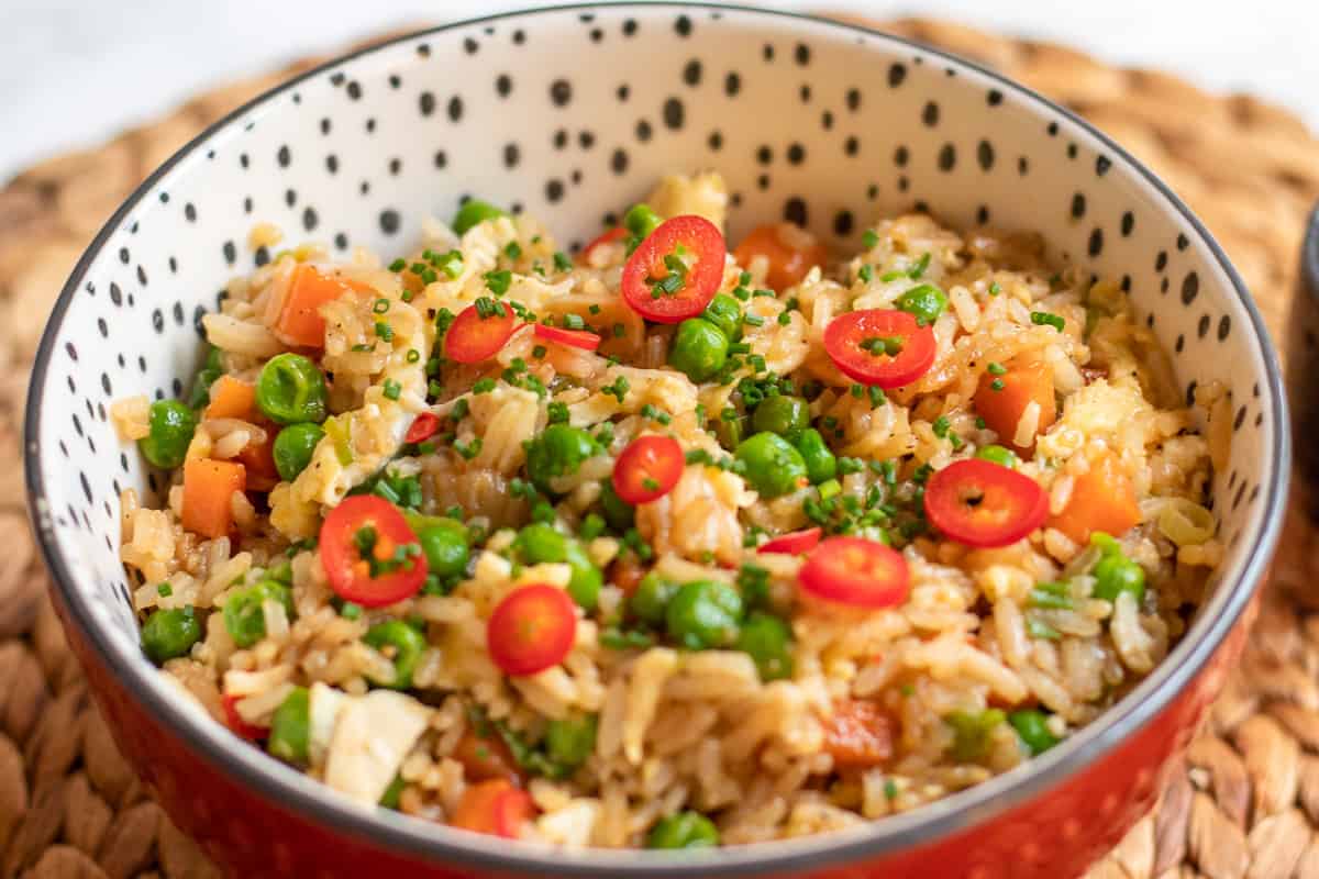 garnish the spicy egg fried rice with spring onions and serve