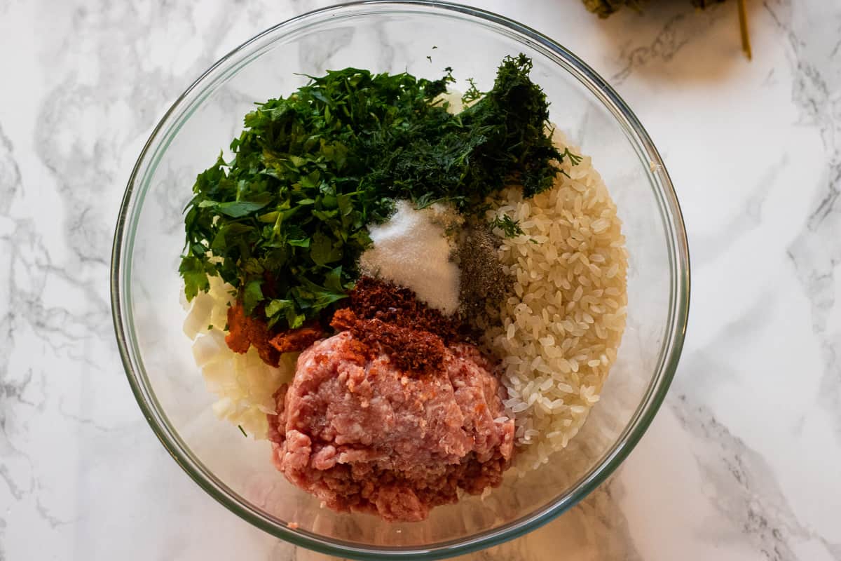 rice, mince, onions and herbs are placed in a bowl