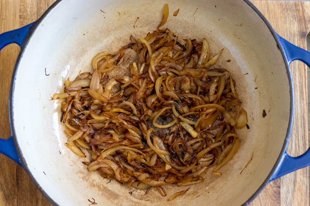 the onions are caramelised with gee in a Dutch oven