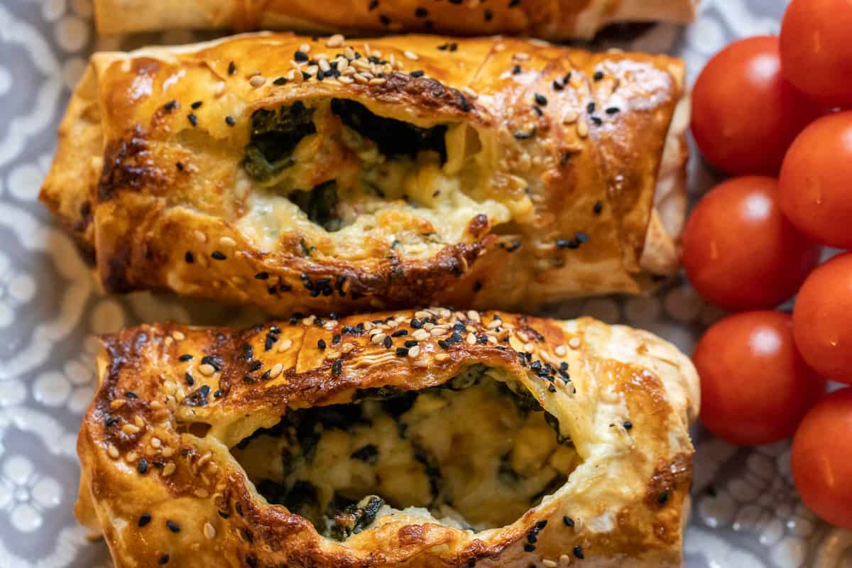 2 pieces of spinach and feta borek served with cherry tomatoes