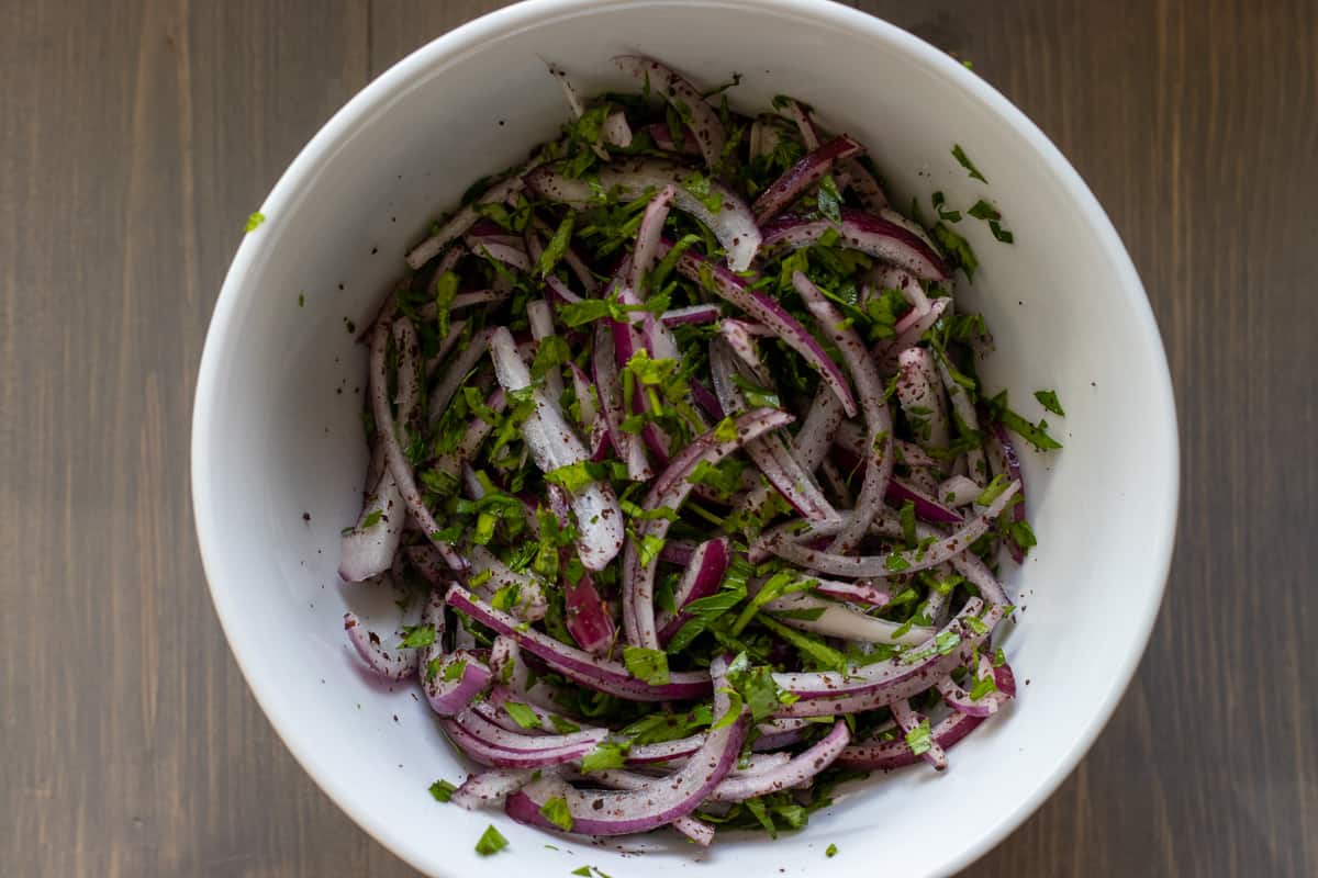 onion, parsley and sumac salad in a bowl 