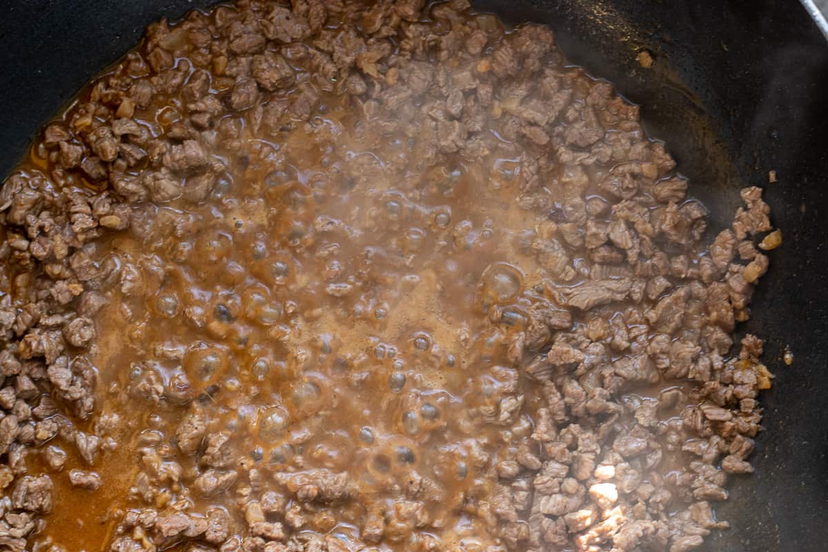 water added to the pan to cook the beef