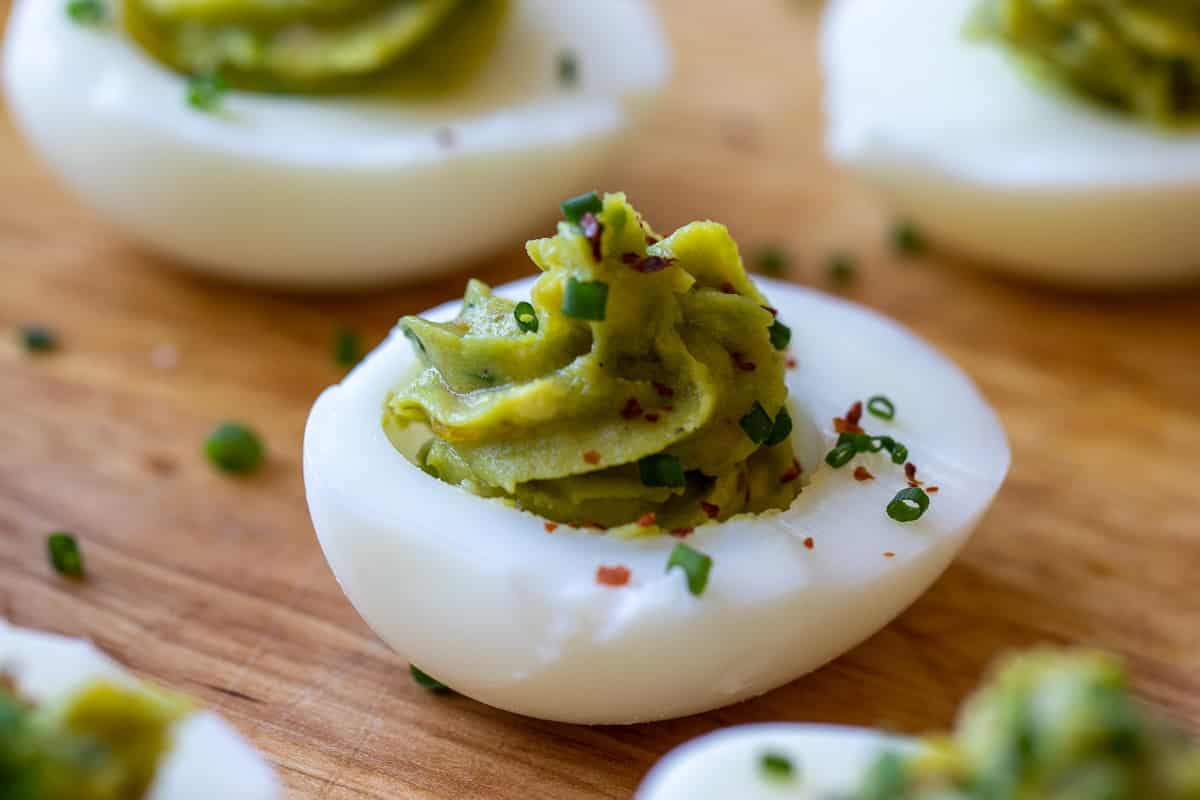 avocado eviled eggs without mayo garnished with chives