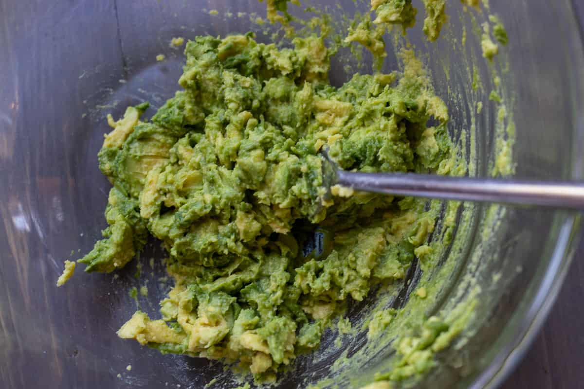 avocado is turned into a mash with a fork