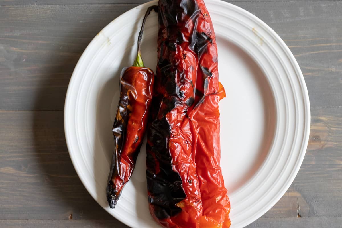 A red pepper and a chili charred on a grill