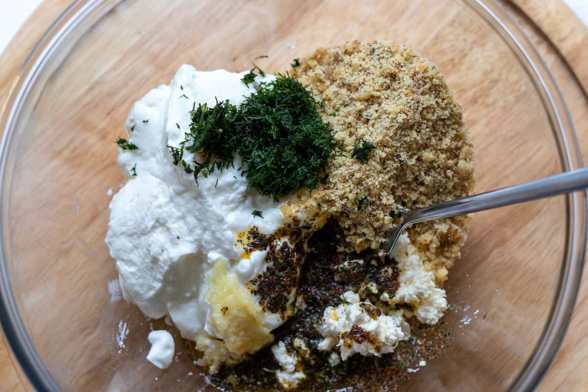 the walnuts, yoghurt and herbs are added to feta