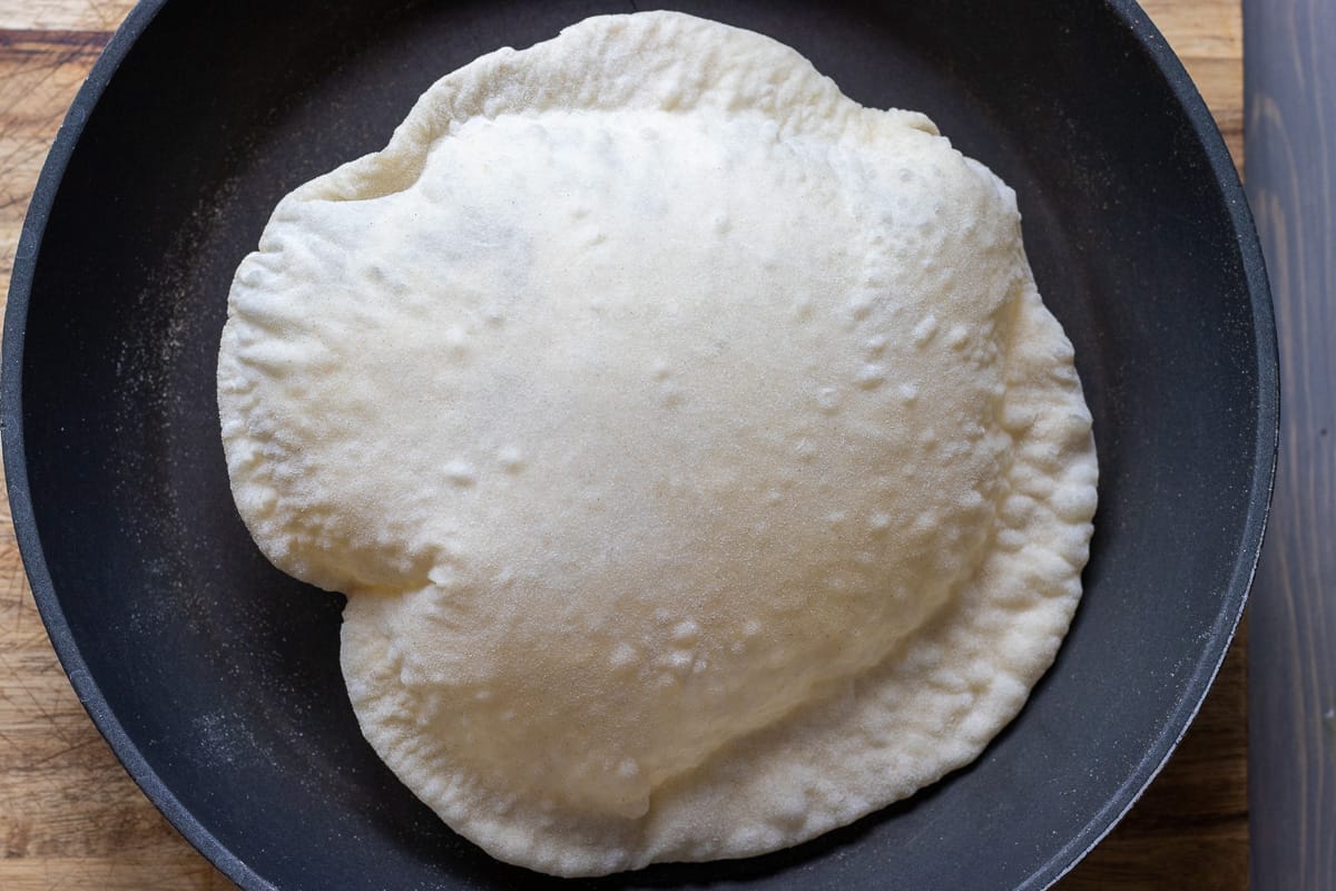 cooking sourdough flatbread in a pan