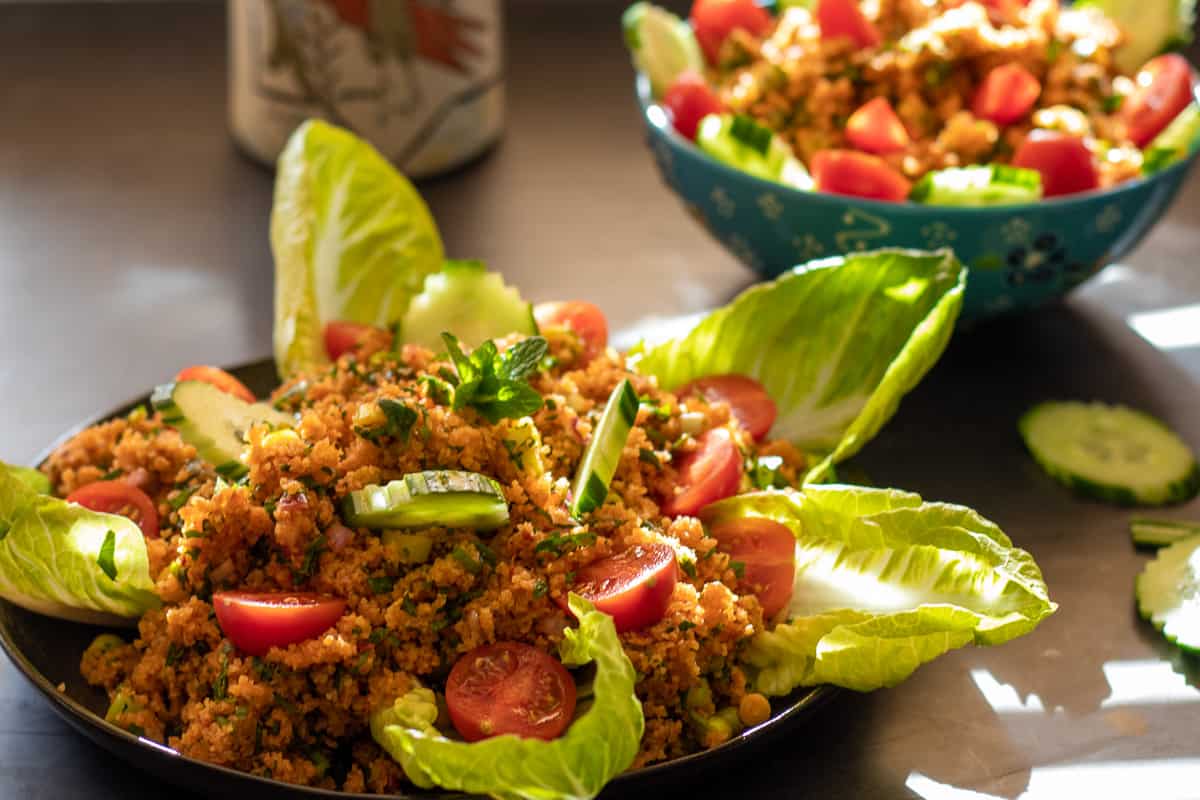 Traditional Kisir Recipe (Spicy Turkish Bulgur Salad) is served with lettuce leaves