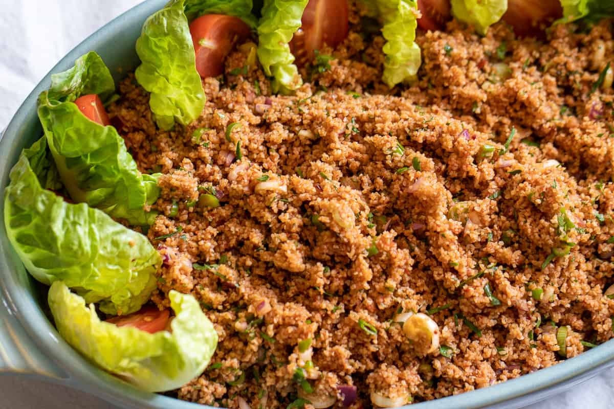 Traditional Kisir Recipe (Spicy Turkish Bulgur Salad) is served with lettuce and tomatoes