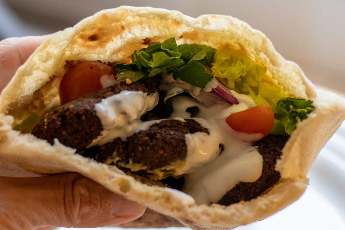 falafel served in a pita bread with salad and tahini sauce