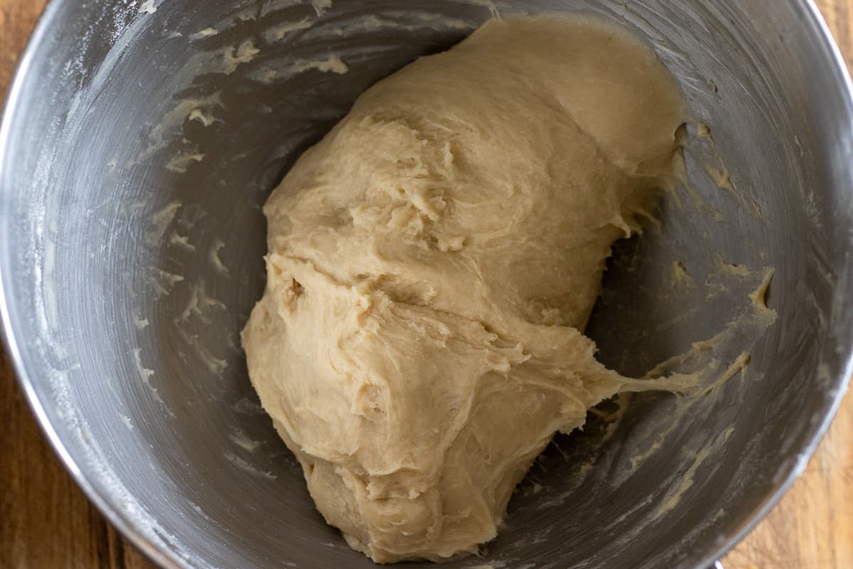 melted butter is gradually added to the dough