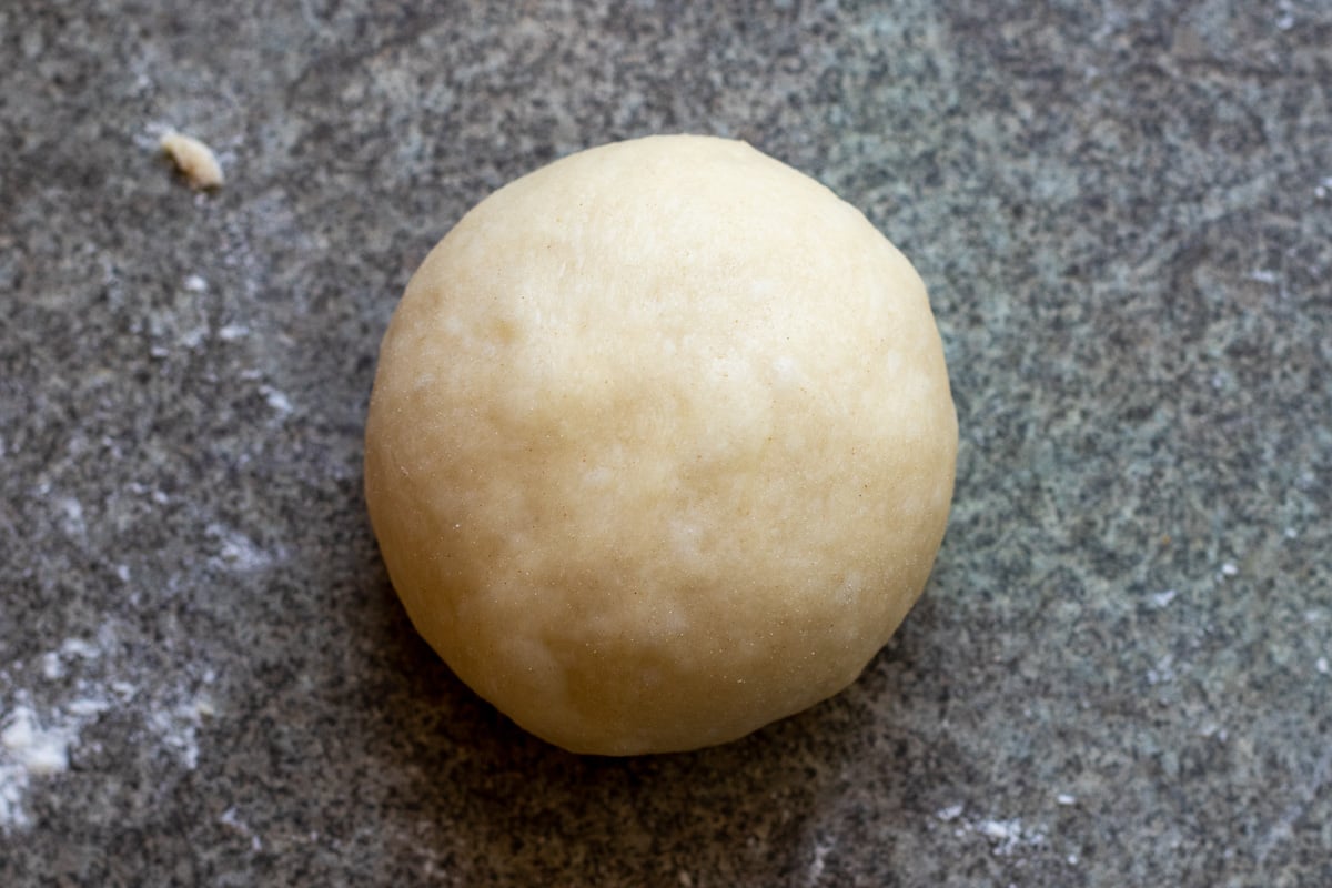 a piece of dough ball shaped into a bun