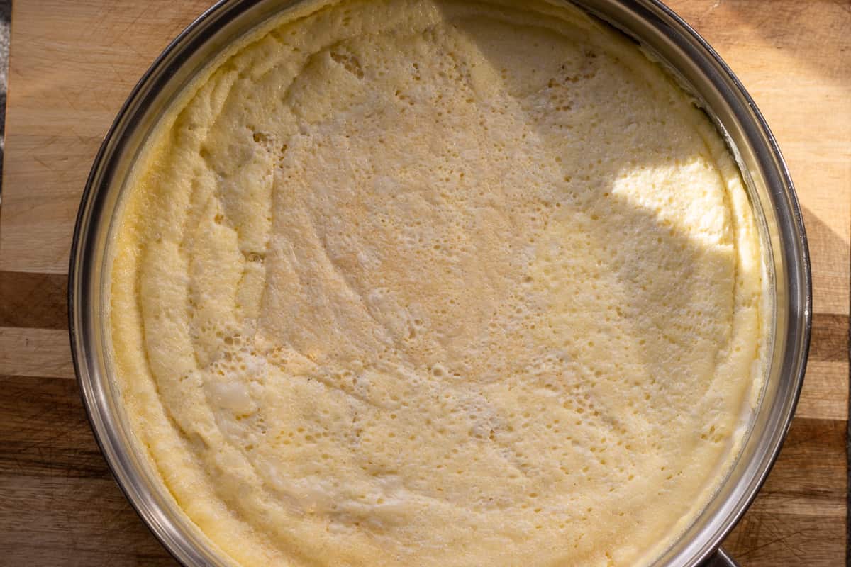 a thick layer of kaymak has formed on top of the simmering milk