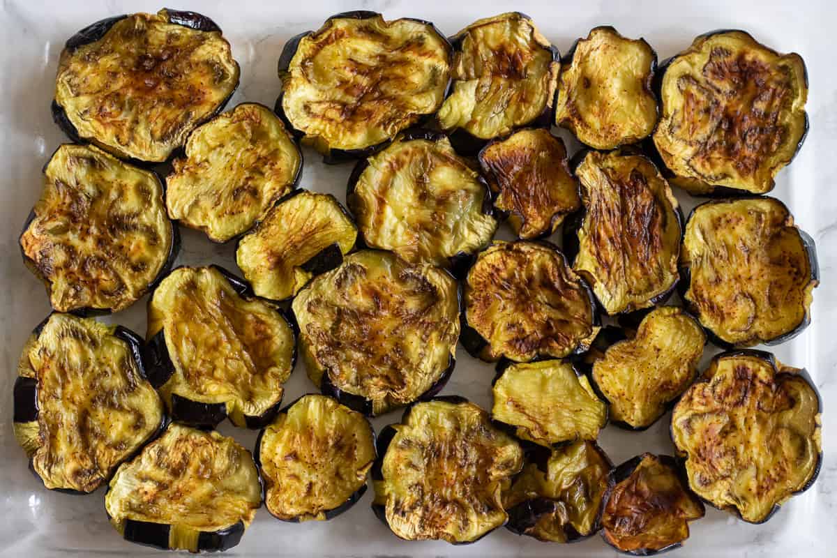 the fried aubergines are arranged in an oven dish
