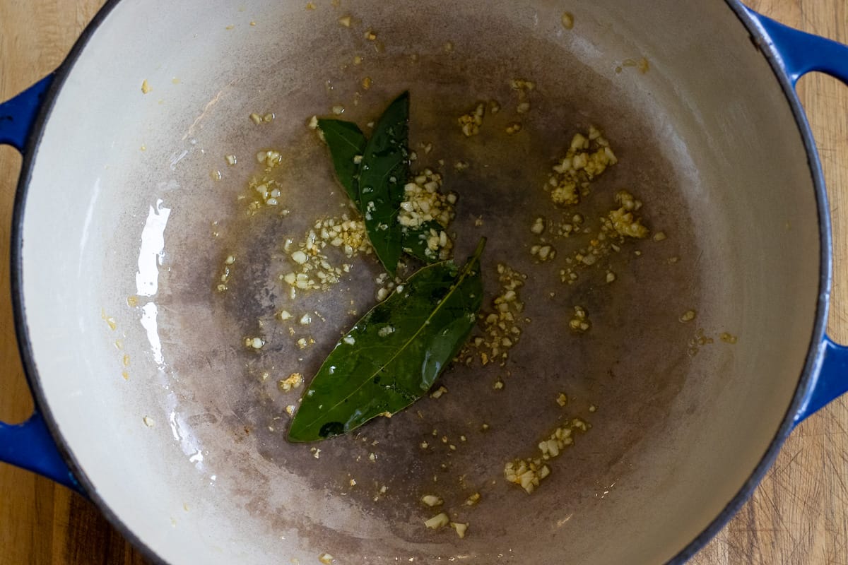 Sautéing the bay leaves and garlic with oil