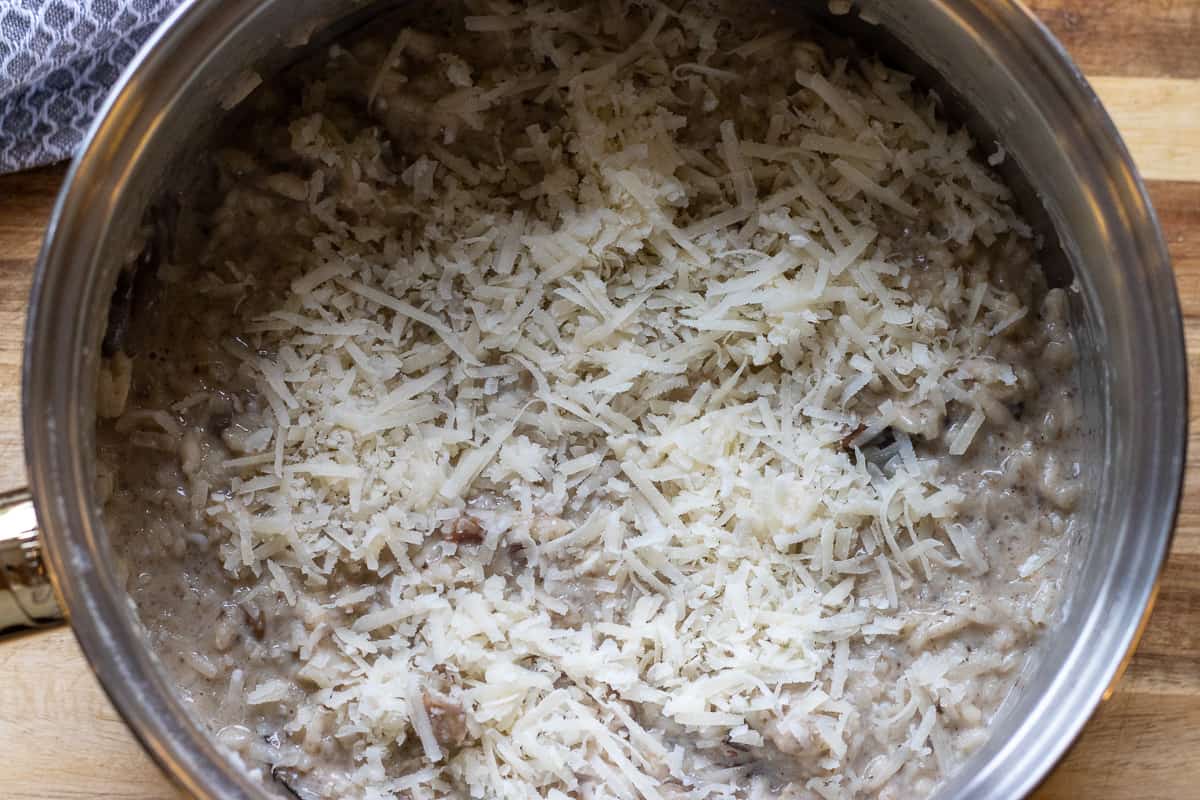 grated parmesan is scattered on top of the risotto