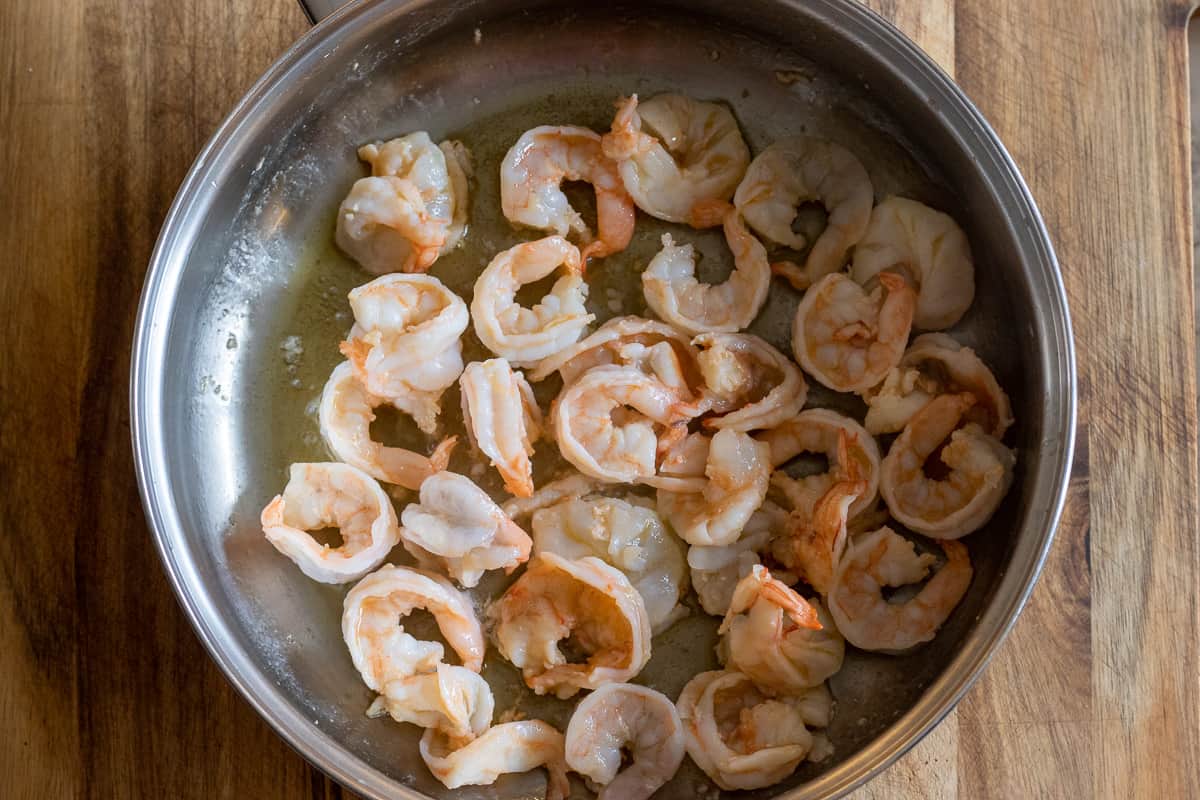 Sautéing the shrimp with butter in a pan