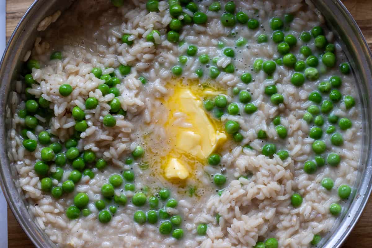 butter and peas are added to risotto