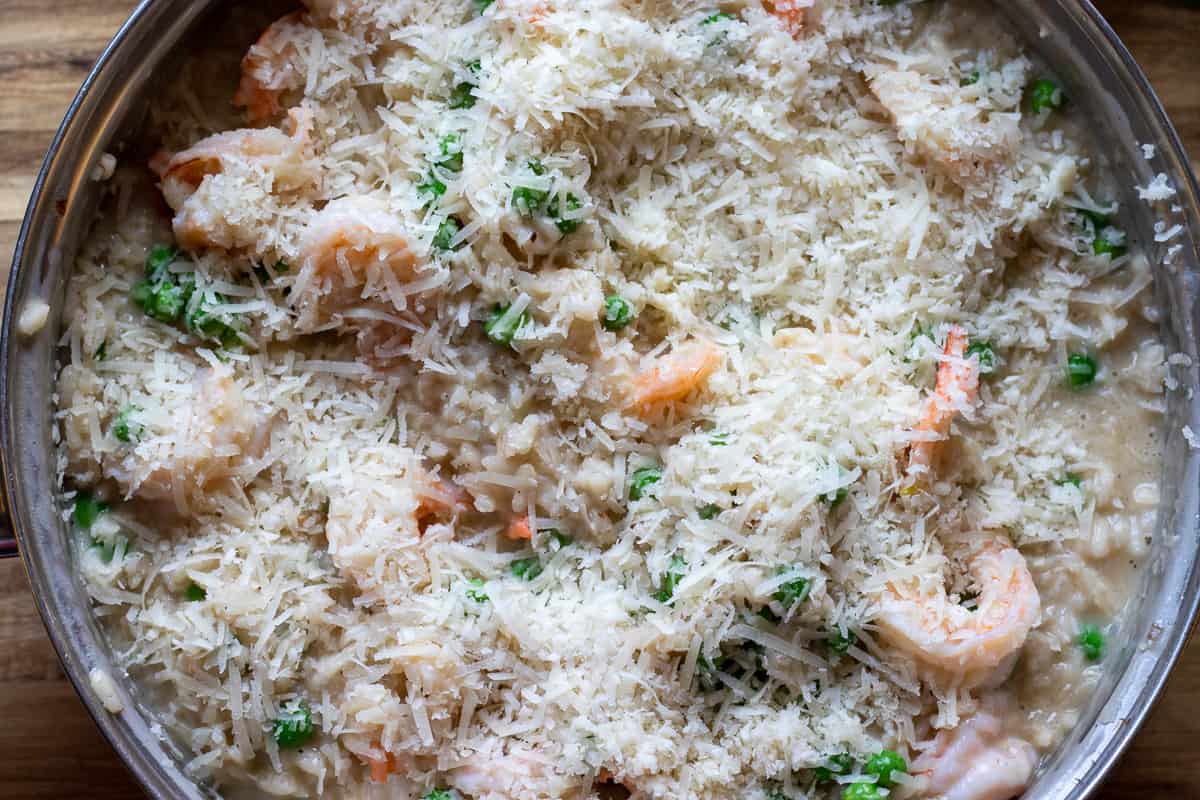shrimp is stirred in the risotto and sprinkled on parmesan cheese