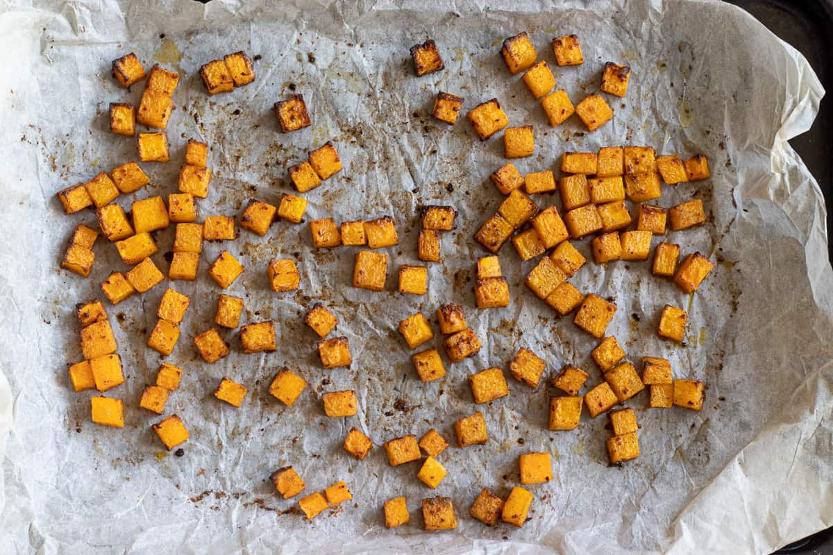 roasted pumkin dices on a baking sheet