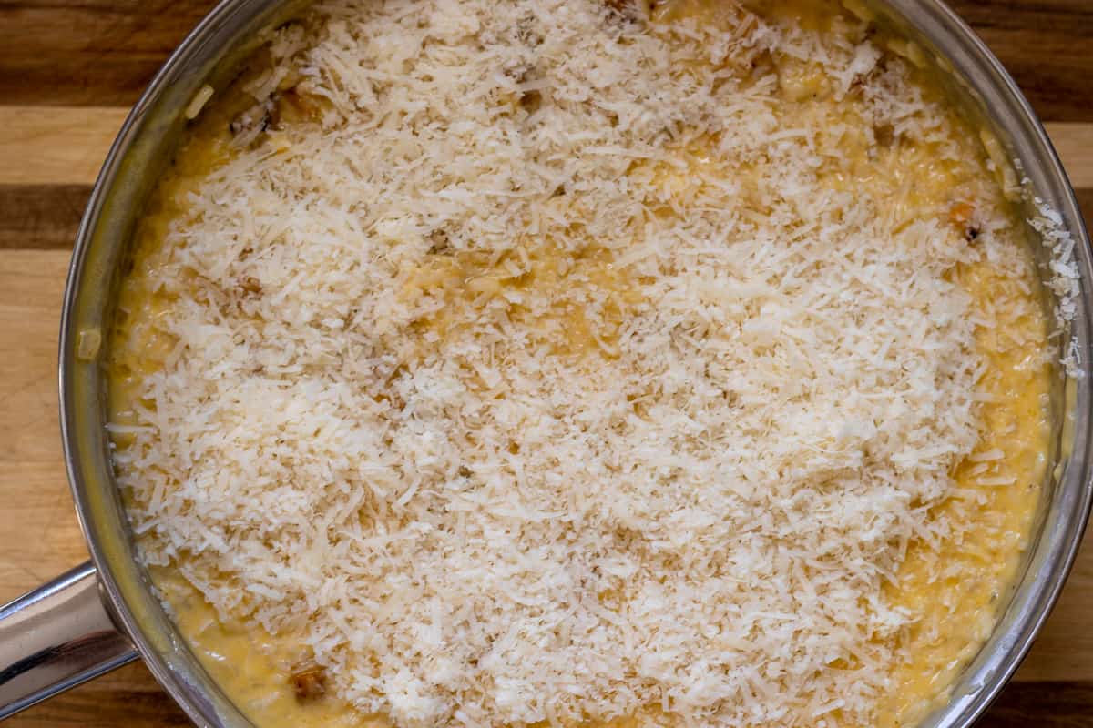 grated parmesan is spread on risotto