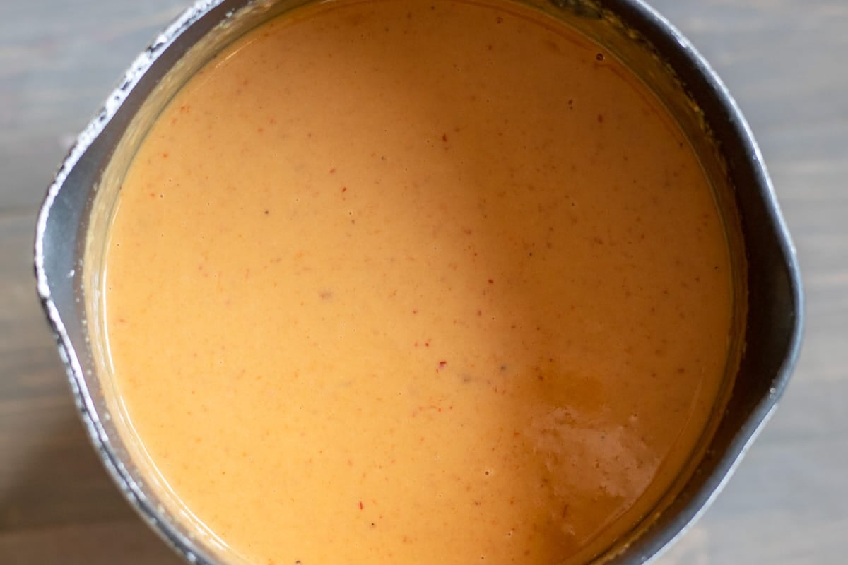 peanut sauce was cooked on stove until it has thickened