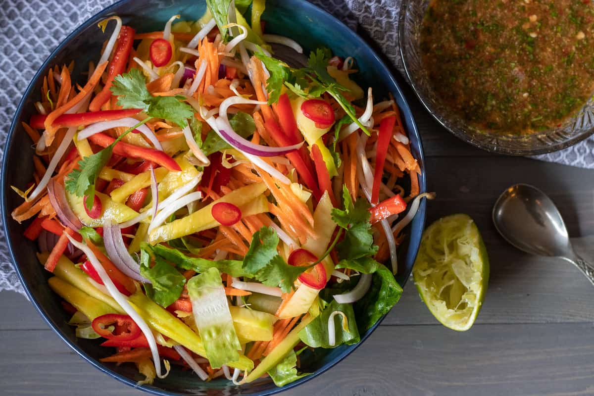 thai mango salad served with a spicy dressing