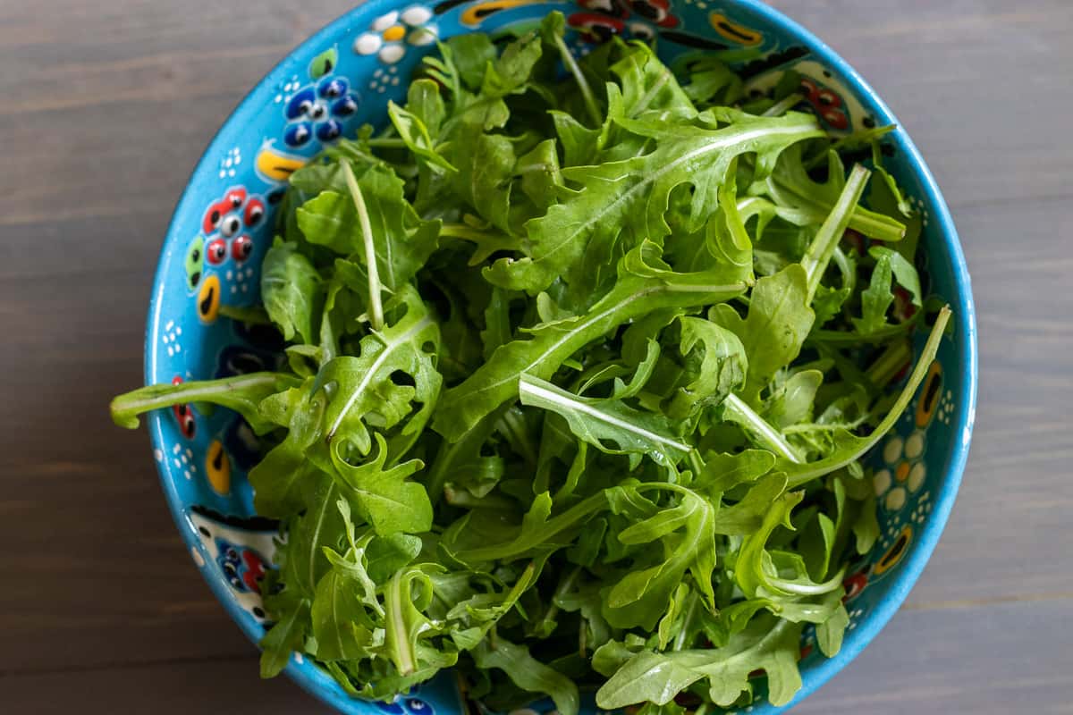 rocket leaves are placed in a bowl