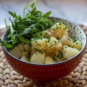 Austrian potato salad served with rocket leaves