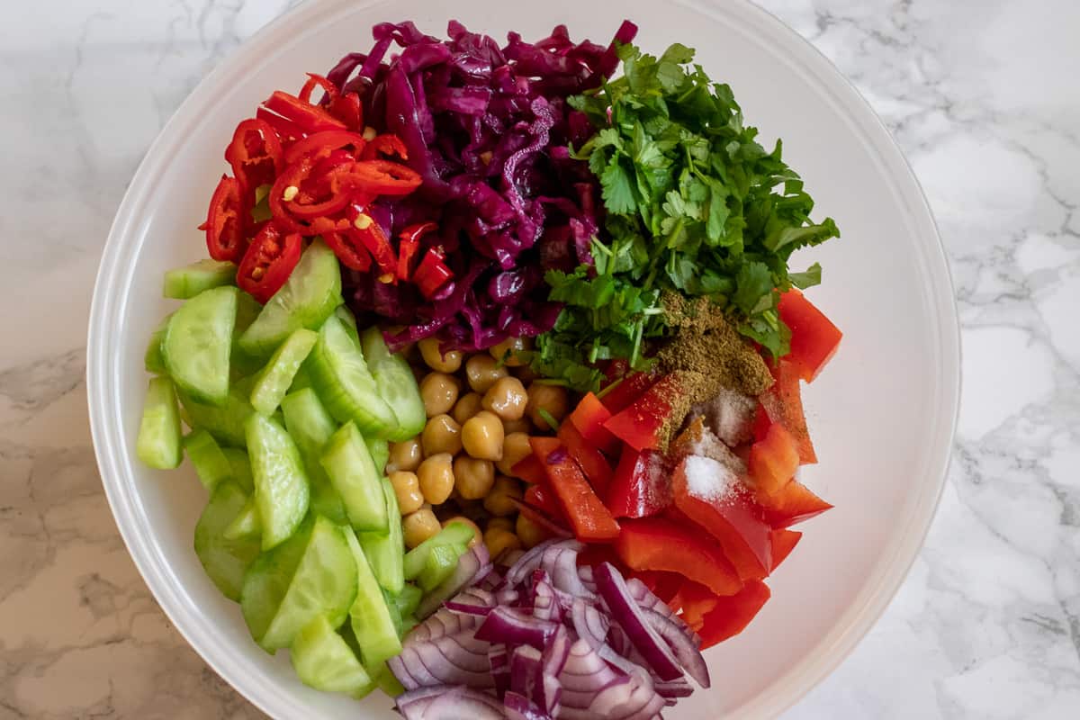 the vegetables, chickpeas, and coriander are placed in a bowl