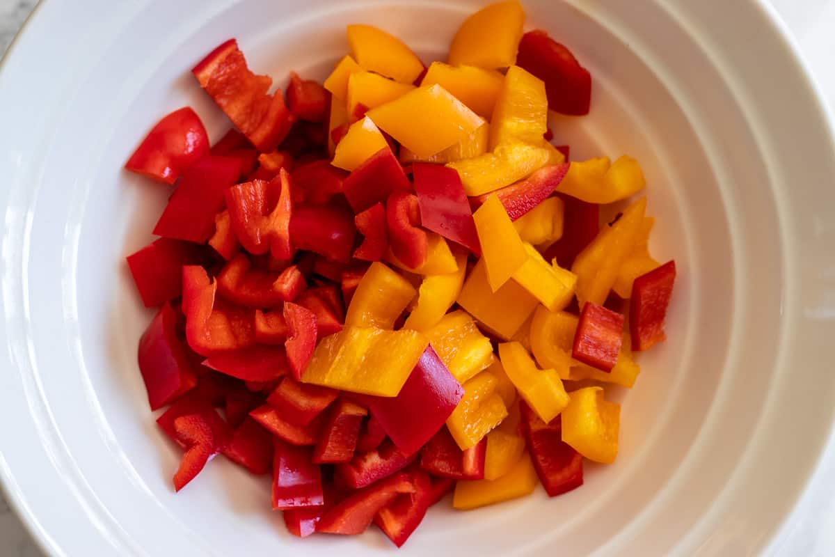diced red and yellow peppers in a bowl