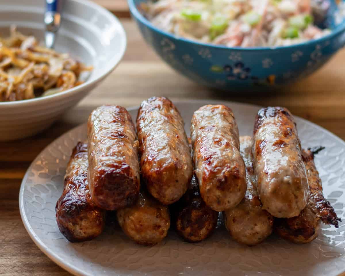 air fryer sausages served with caramelised onions and Russian salad