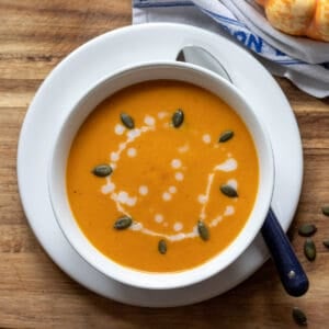 spiced butternut squash soup served in a bowl with pumpkin seeds