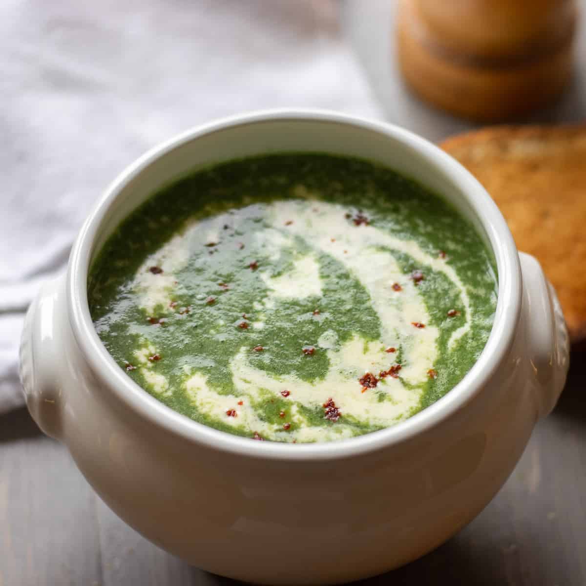 wild garlic soup served with a drizzle of cream